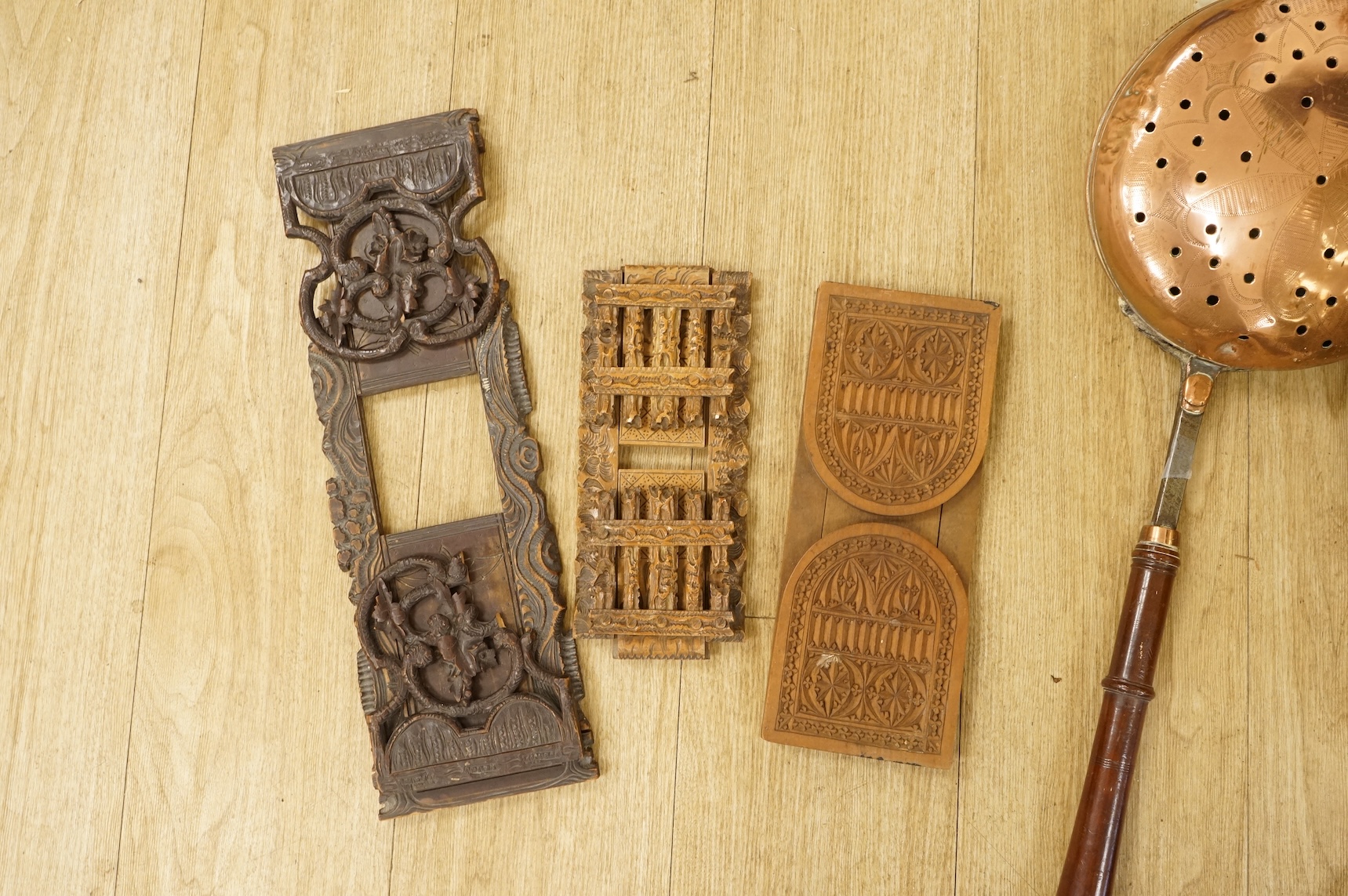 A 19th century Dutch brass coal bin, a pair of wall sconces, a copper bed warmer and three book slides